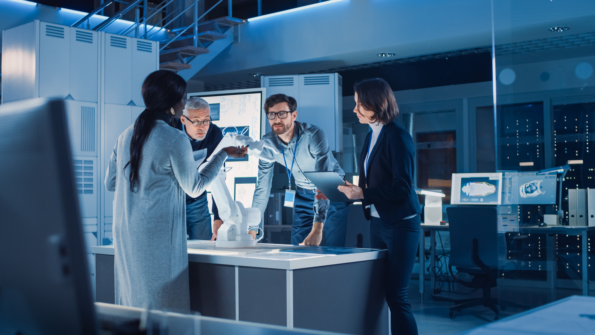 People working around robotic arm